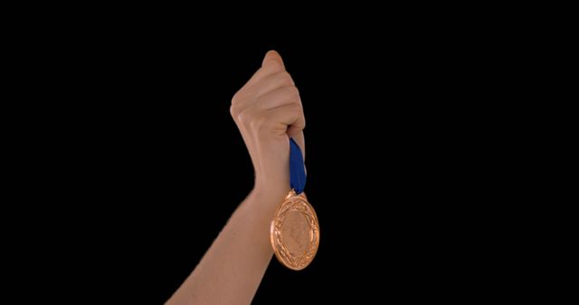 Hand Holding Gold Medal with Blue Ribbon on Black Background - Download Free Stock Images Pikwizard.com