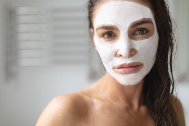 Woman Applying Facial Mask in Bathroom - Download Free Stock Photos Pikwizard.com