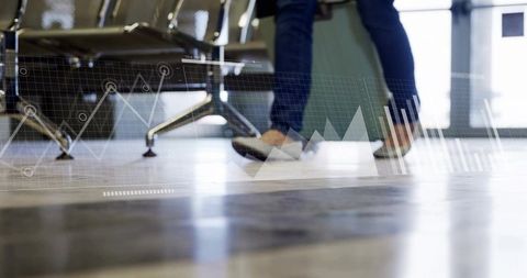 Traveler with Suitcase Walking in Modern Airport Hallway