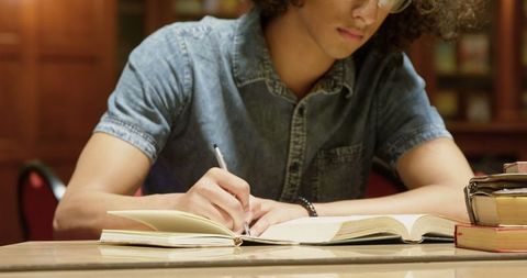 Young man focused on studying in library