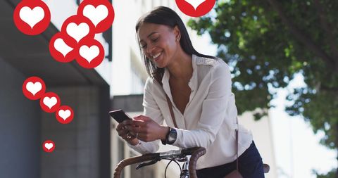 Woman Smiling with Smartphone Surrounded by Love Icons in Urban Setting
