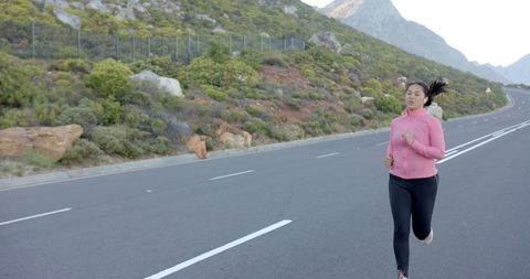 Woman Jogging on Scenic Mountain Road Side View