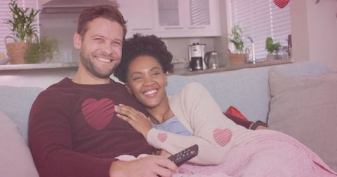 Diverse Couple Relaxing on Sofa Watching TV