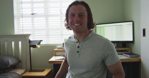 Smiling Man with Disability Working at Home Office