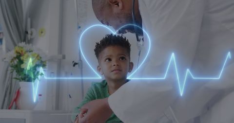 Compassionate African American Doctor with Young Patient and Heart Monitor Graphic