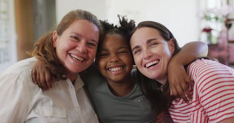Joyful Lesbian Couple with Daughter Smiling Happily Together