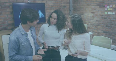 Diverse Coworkers Analyzing Reports with Digital Technology