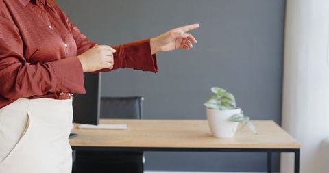 Businesswoman Gesturing During Presentation in Modern Office