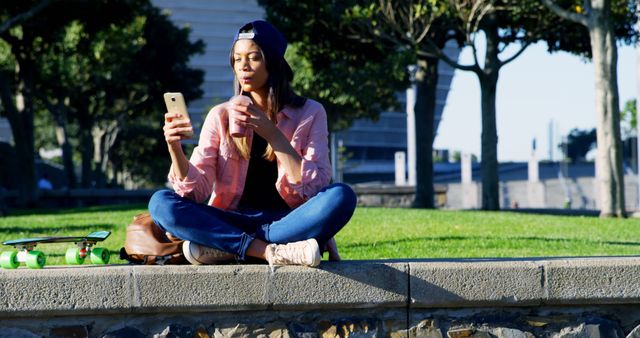 Young Woman Enjoying Drink While Video Chatting in Park - Download Free Stock Images Pikwizard.com