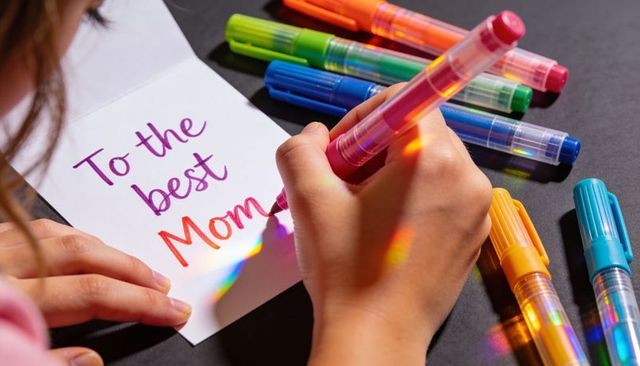 Child Writing Colorful Mother's Day Card with Rainbow Gel Pens and Iridescent Highlights