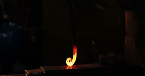 Blacksmith Forging Hot Iron in Traditional Workshop