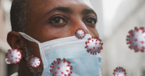 Man Wearing Mask Surrounded by COVID-19 Cells