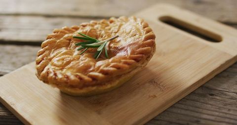Homemade rustic pot pie on wooden cutting board