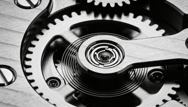 Turning balance wheel and hairspring on mechanical watch macro closeup for horology