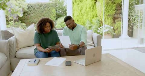 Mature Couple Reviewing Financial Documents on Patio