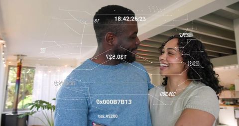 Smiling couple exploring augmented reality home tech in open-plan living room, lifestyle