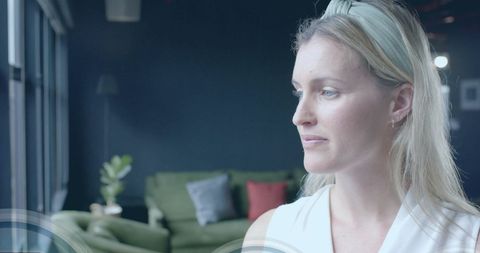 Businesswoman with digital security symbols in modern office