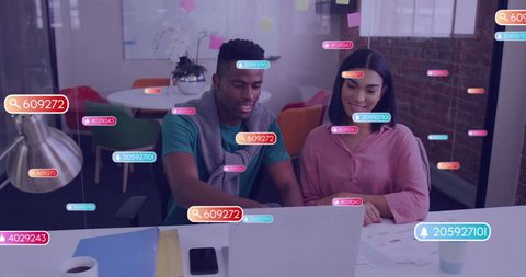 Diverse Colleagues Analyzing Digital Metrics in Modern Office