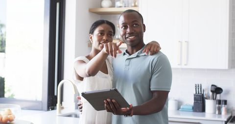 Happy Couple Using Tablet in Modern Kitchen, Engaging Together - Download Free Stock Images Pikwizard.com
