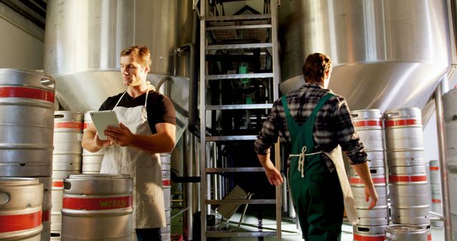 Brewery Production Workers Managing Beer Kegs and Equipment - Download Free Stock Images Pikwizard.com