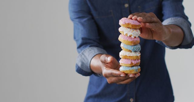 Man Holding Stacked Colorful Sprinkle Donuts - Download Free Stock Images Pikwizard.com