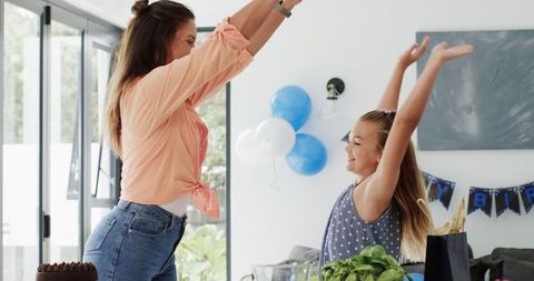 Mother with Daughter Celebrating Birthday in Living Room