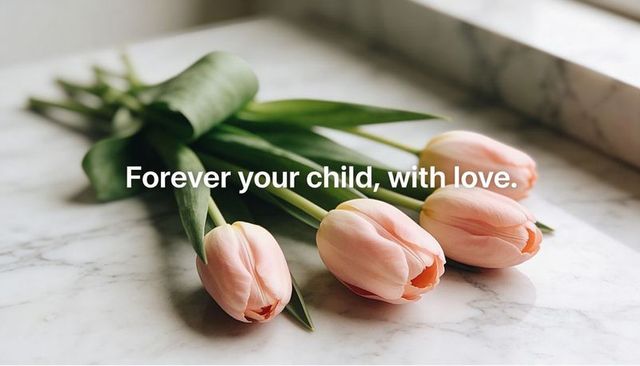 Peach pink tulips lying on marble countertop with soft light and elegant text overlay