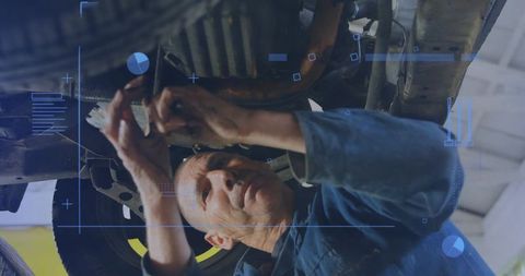 Automotive Technician Inspecting Undercarriage on Lift with HUD Diagnostics