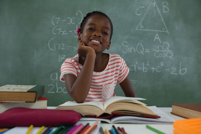 Smiling African American Schoolgirl Reading Book in Classroom - Download Free Stock Photos Pikwizard.com