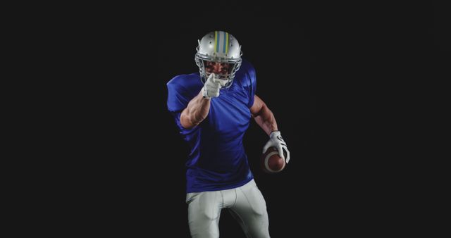 American Football Player Pointing with Intensity Against Dark Background - Download Free Stock Images Pikwizard.com
