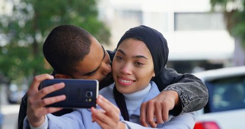 Happy Couple Embracing and Taking Selfie on City Street - Download Free Stock Images Pikwizard.com