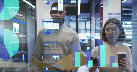Diverse Colleagues Analyzing Data in Modern Office with Digital Interface