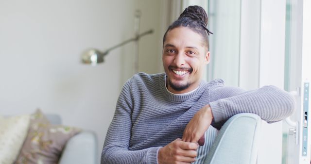 Smiling African American Man Relaxing on Couch in Modern Living Room - Download Free Stock Images Pikwizard.com