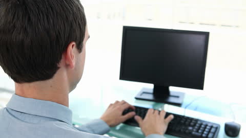 Business Professional Typing at Computer in Office Environment