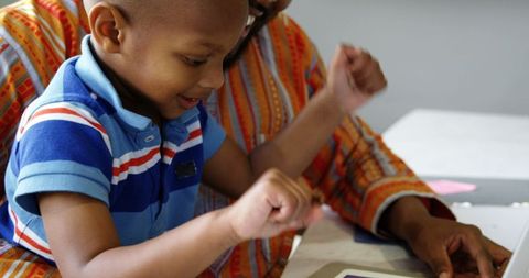 Father and Son Enjoying Technology Together at Home