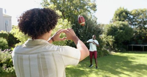 Friends enjoying outdoor american football at home
