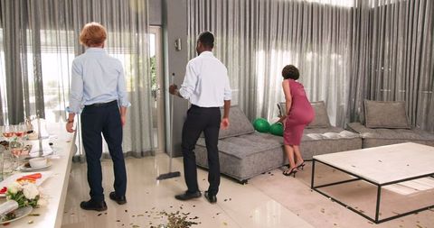 Friends Tidying Up After Wedding Reception at Home