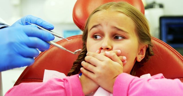 Young patient scared during a dental check-up at clinic