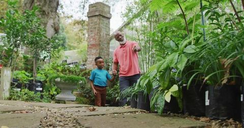 Grandfather and Grandson Exploring Garden Nursery for Family Bonding