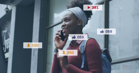 African American Woman Engaging with Social Media Notifications Outdoors