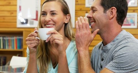 Smiling Couple Chatting Over Tea in Relaxing Environment