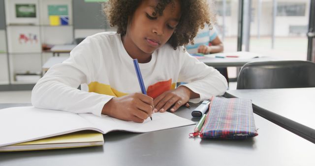 Focused Young Student Taking Notes in Classroom - Download Free Stock Images Pikwizard.com