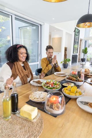 African american couple sharing cozy family dinner in sunlit open-plan kitchen