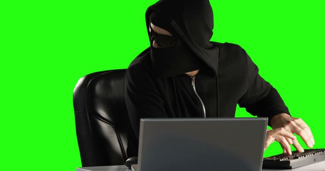 Hacker in Black Hoodie Typing on Keyboard in Green Screen Setting - Download Free Stock Images Pikwizard.com