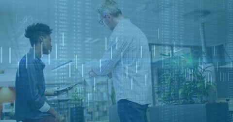 Mixed-Race Coworkers Analyzing Data on Tablet in Modern Office