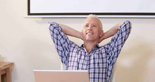 Senior Man Relaxing at Desk with Hands Behind Head - Download Free Stock Images Pikwizard.com