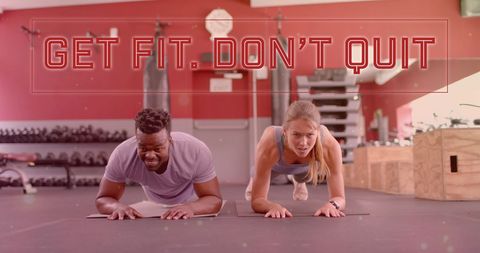 Motivated Fitness Enthusiasts Planking in Modern Gym