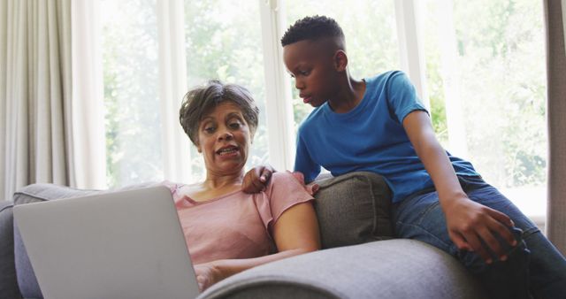 Grandmother Teaching Grandson to Use Laptop at Home - Download Free Stock Images Pikwizard.com