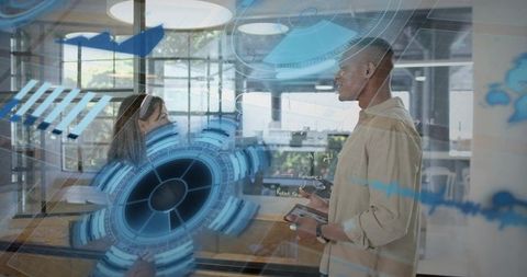 Business team collaborating with augmented reality interface in modern glass office
