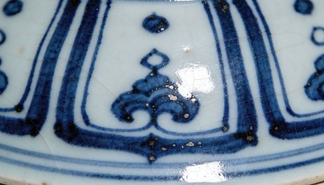 Handpainted cobalt-blue porcelain band showing arabesque motif, glazed craquelure close-up